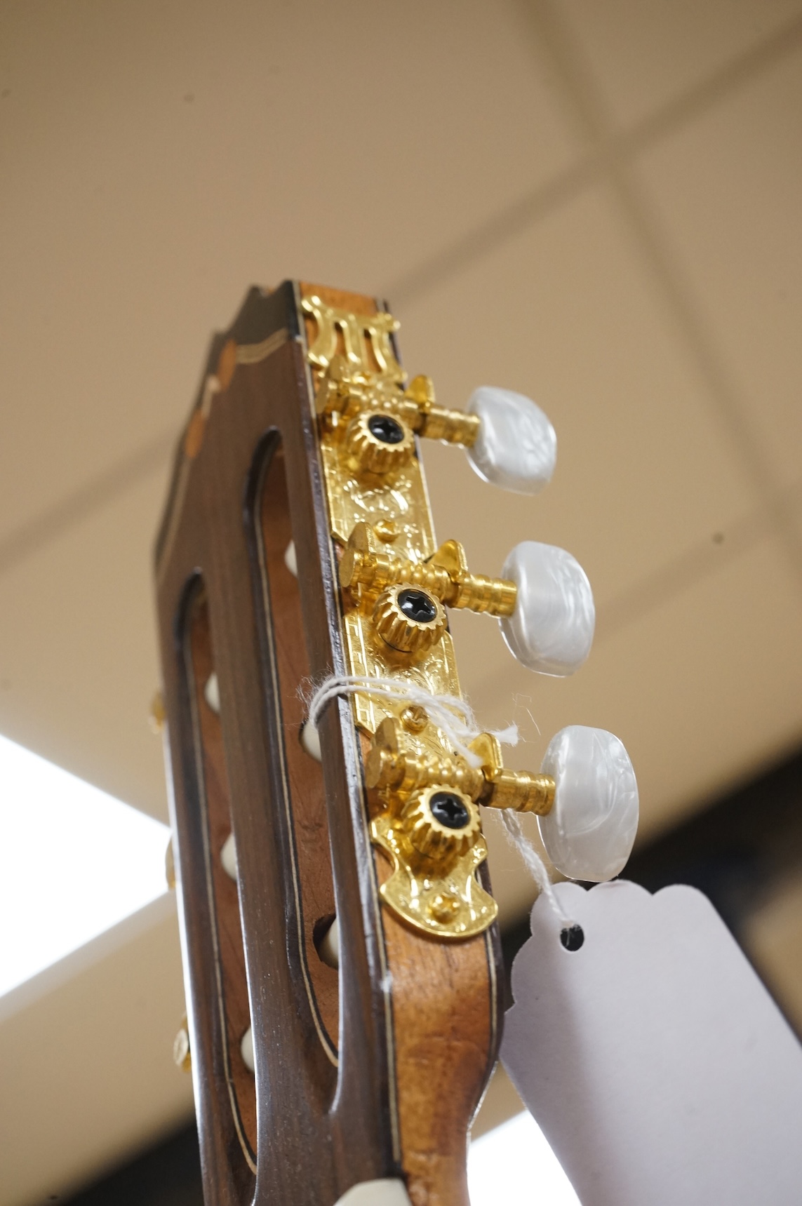 A handmade cedar, Indian Rosewood and ebony classical guitar by 'an English Luthier', with label to the inside of the body, together with a soft case.